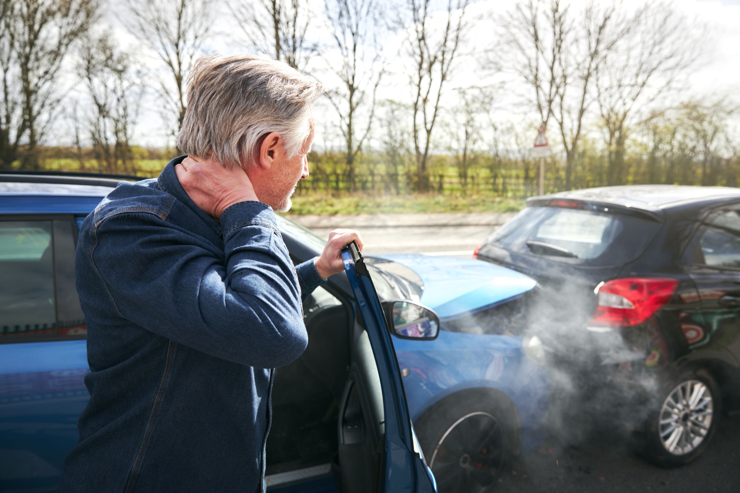 man with a sore neck after a car accident needing a chiropractor for relief