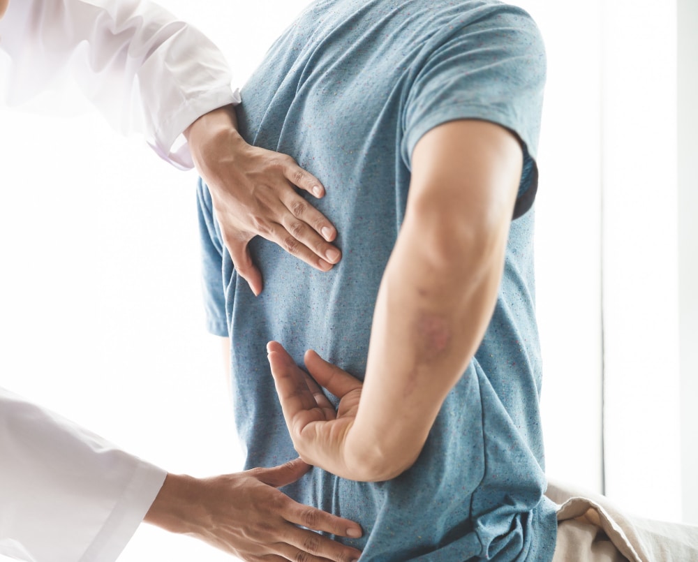 Chiropractor adjusting back of patient after car accident in Frankfort