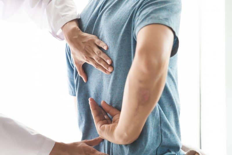 Chiropractor examining patient after car accident in Frankfort KY