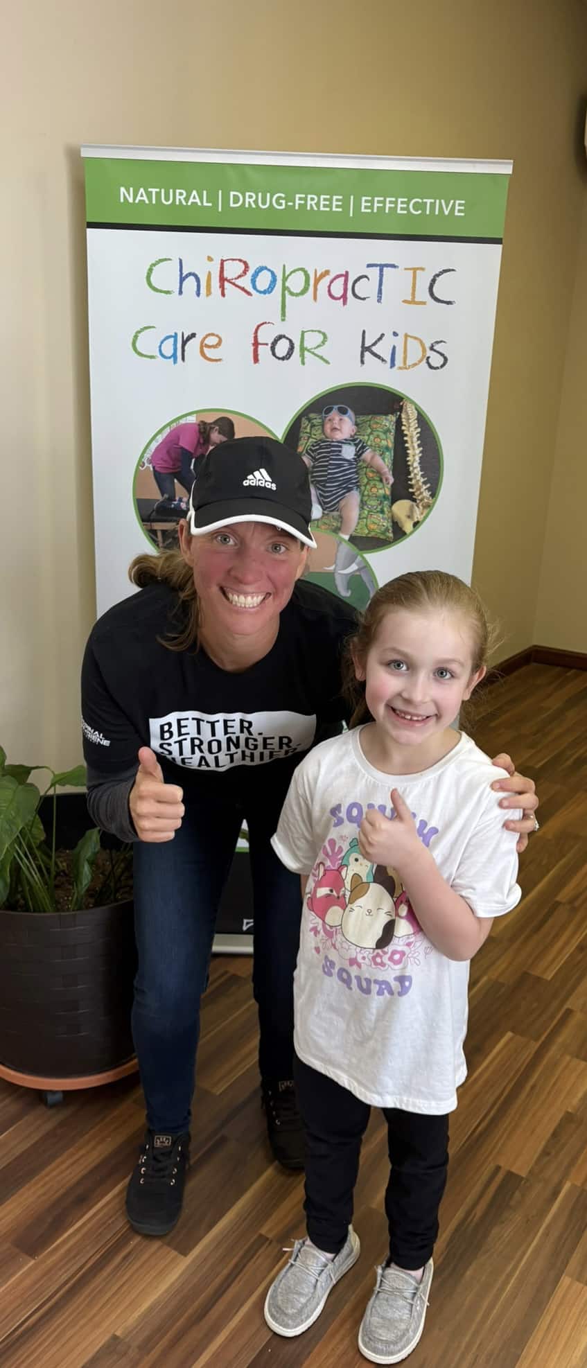 Chiropractor with young pediatric patient smiling after gentle chiropractic care in Frankfort KY